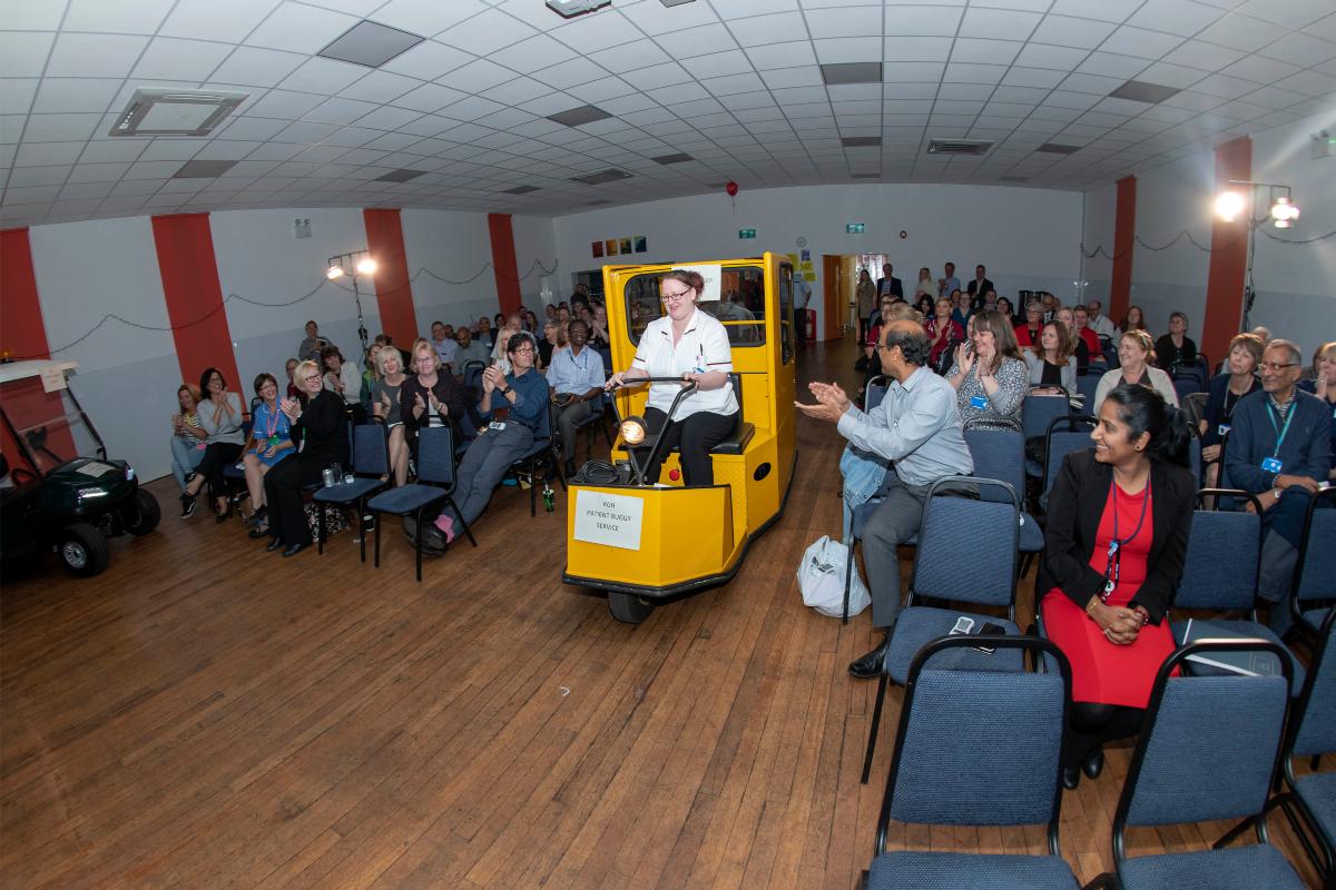 Photo of patient buggy being driven up gangway the Dragons Den Event.