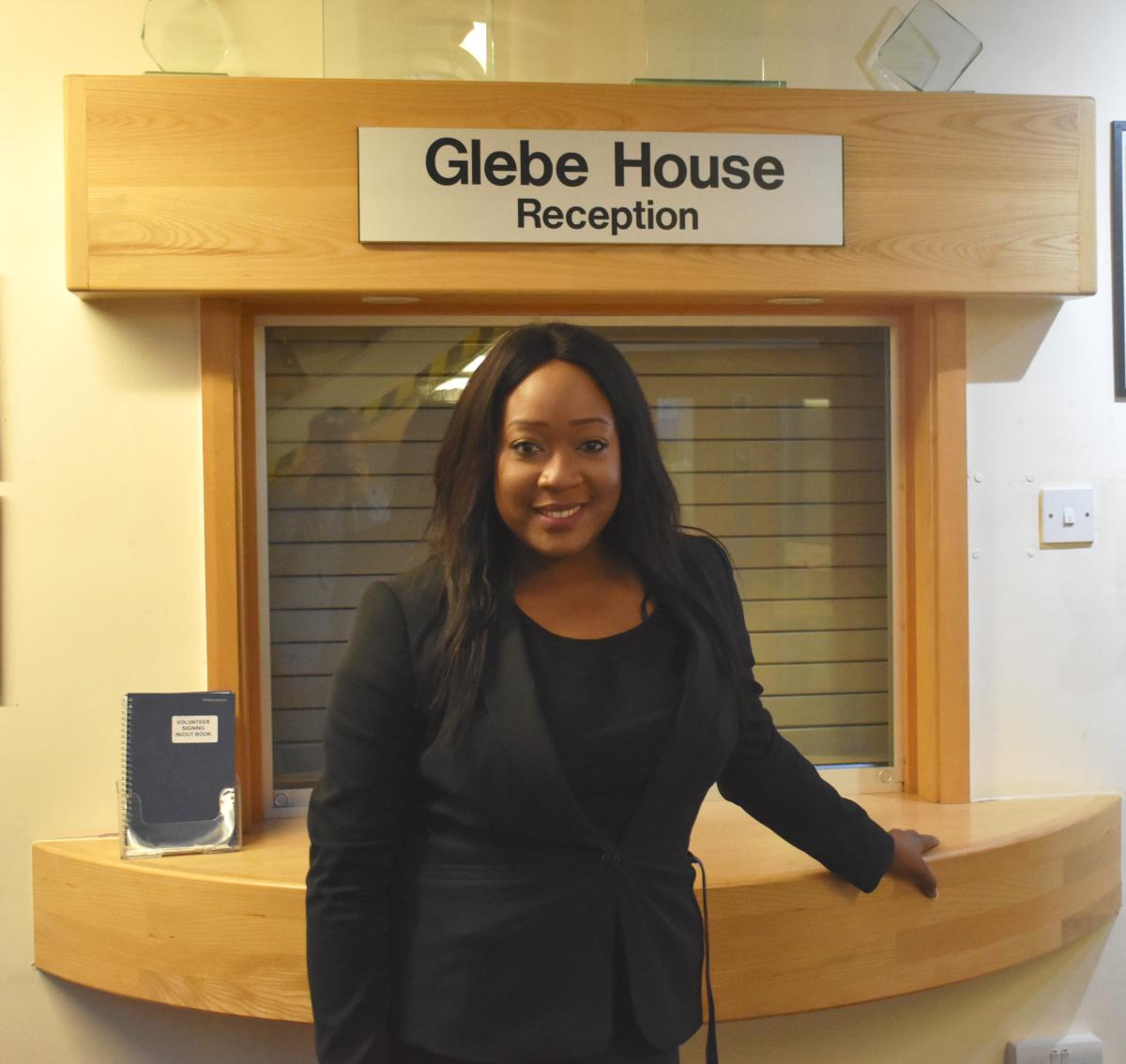 Anna Awoliyi Chief Allied health Information Officer standing in front of Glebe House KGH